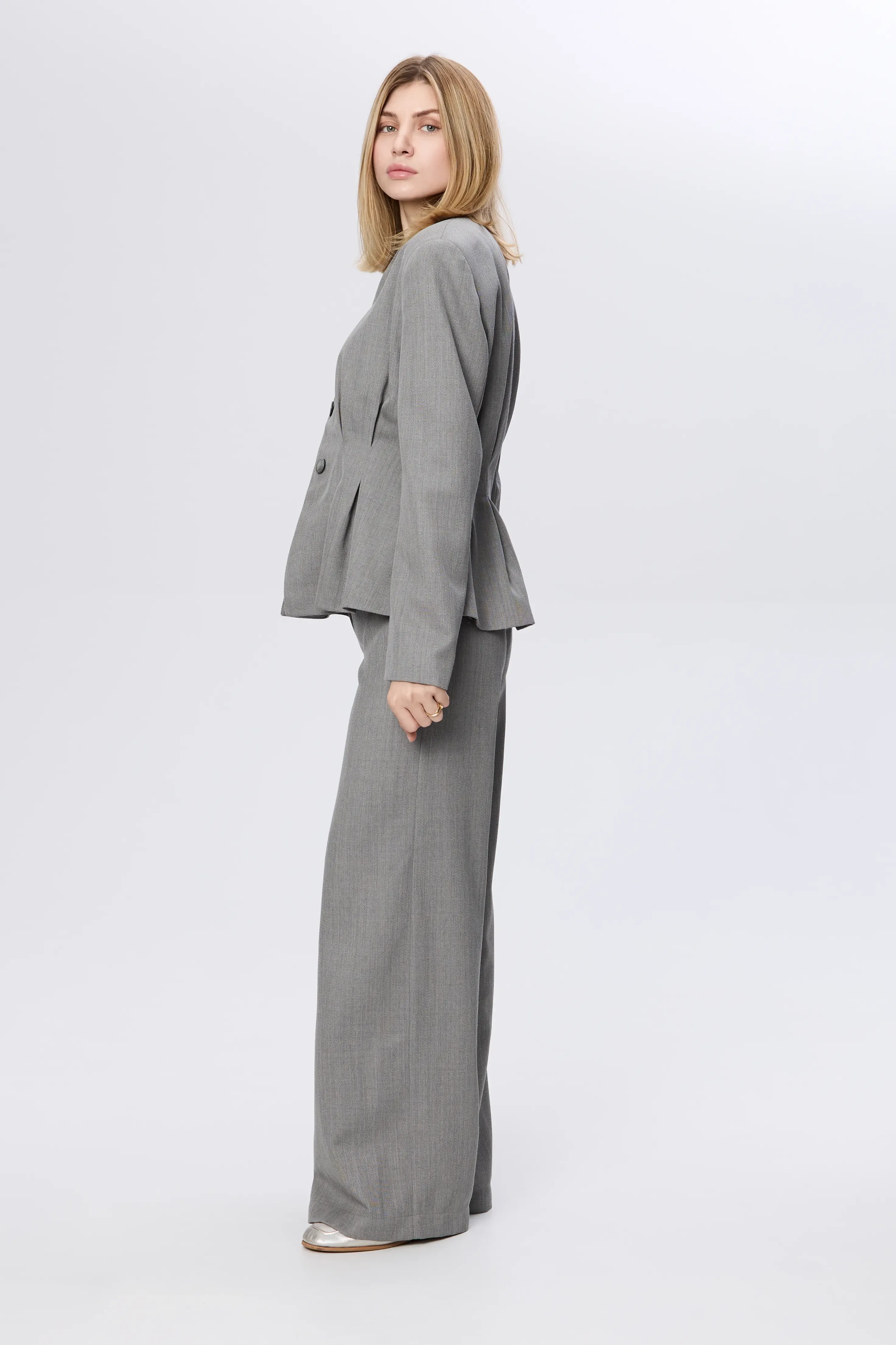 Sculptural jacket with pleated waist in fine wool