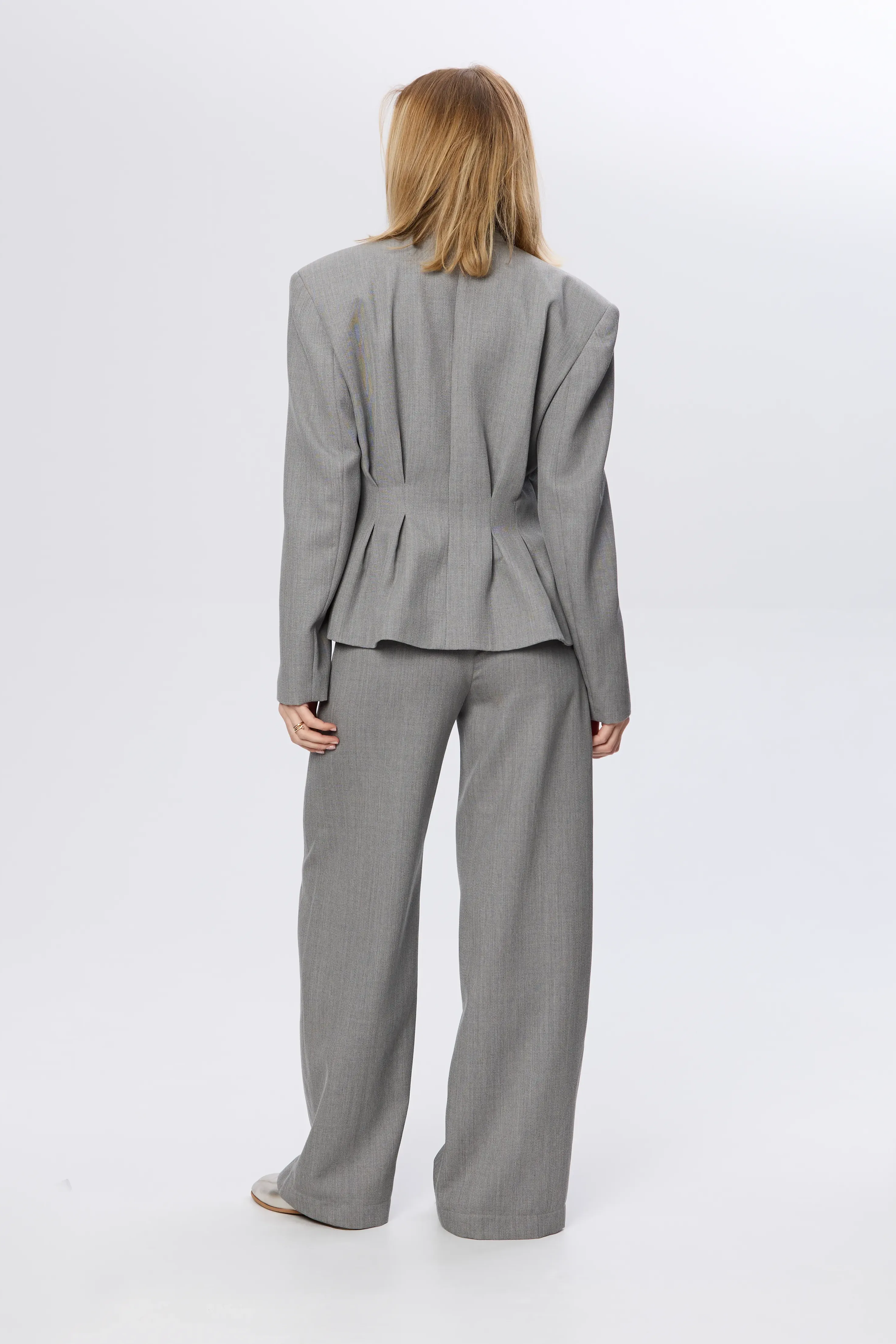 Sculptural jacket with pleated waist in fine wool